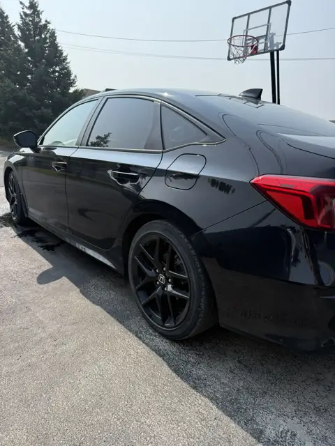Black sedan, foam wash and gloss finish